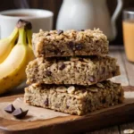 Ingredients for making banana oat bars, including mashed bananas, oats, and peanut butter.